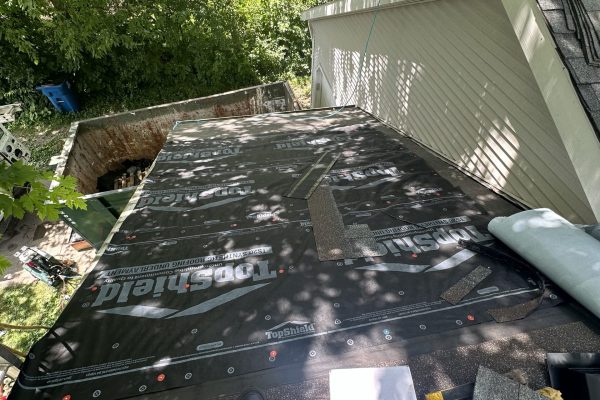 IMG_5271 Looking down a steep roof incline while roofers work on a roof replacement job
