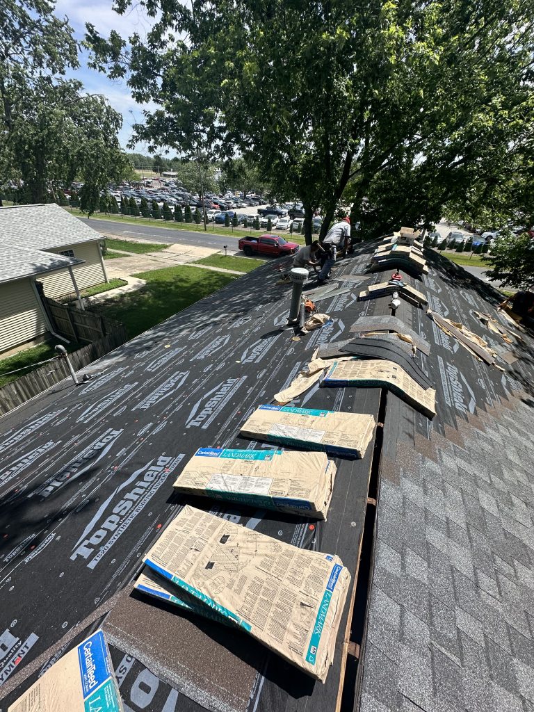 Pantheon Roofing Solutions working on a roof in Champaign, IL