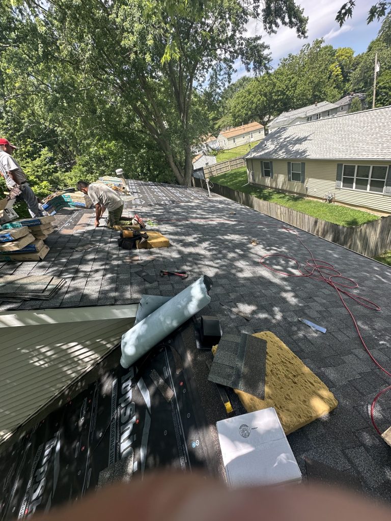 Roofers working for Pantheon Roofing Solutions preparing to replace a roof in Champaign, IL