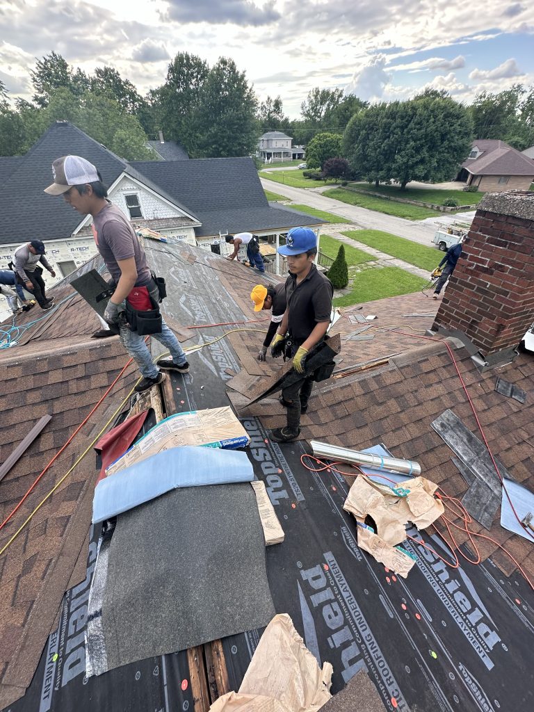 Roofers working on a roof replacemnt - Pantheon Roofing Solutions